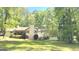 Traditional home with a manicured lawn and mature trees, providing shade and privacy at 15 Perthshire Dr, Peachtree City, GA 30269