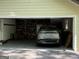 View of spacious garage featuring a silver vehicle and storage shelving, enhancing functionality and organization at 15 Perthshire Dr, Peachtree City, GA 30269