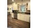 Bright kitchen boasts stainless steel appliances, double sink, and white shaker-style cabinets at 15 Perthshire Dr, Peachtree City, GA 30269
