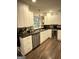 Charming kitchen with stainless dishwasher, granite countertops, and white cabinets at 15 Perthshire Dr, Peachtree City, GA 30269