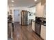 Open kitchen with stainless steel refrigerator, granite countertops, and view to dining area at 15 Perthshire Dr, Peachtree City, GA 30269