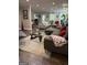 Open-concept living area with a comfortable sofa, hardwood floors, and plenty of natural light at 15 Perthshire Dr, Peachtree City, GA 30269