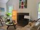Stylish living room with a fireplace, hardwood floors, a guitar, and comfortable seating at 15 Perthshire Dr, Peachtree City, GA 30269