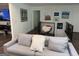 Relaxing living area with neutral tones, modern artwork, and a comfortable gray sofa at 15 Perthshire Dr, Peachtree City, GA 30269