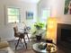 Bright living room featuring stylish furniture, a fireplace, and natural light from two windows at 15 Perthshire Dr, Peachtree City, GA 30269