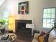 Inviting living room with fireplace, guitar, and comfortable seating at 15 Perthshire Dr, Peachtree City, GA 30269