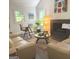 Bright living room featuring stylish furniture, a fireplace, and natural light from two windows at 15 Perthshire Dr, Peachtree City, GA 30269