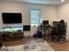 Office space with hardwood floors, a large TV, a large gaming desk, and a large comfy chair at 15 Perthshire Dr, Peachtree City, GA 30269