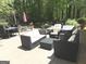 Outdoor patio with comfortable seating arrangements, an umbrella, and lush greenery, perfect for entertaining at 15 Perthshire Dr, Peachtree City, GA 30269