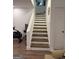 Well-lit staircase with stained wood treads and white risers at 15 Perthshire Dr, Peachtree City, GA 30269