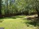 Well-maintained lawn with tall trees along the backyard's perimeter, offering privacy and shade at 3999 Cumberland Se Trl, Conyers, GA 30094