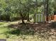 Backyard view showcasing a shed, mature trees, and landscaping at 3999 Cumberland Se Trl, Conyers, GA 30094