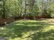 Expansive back yard with privacy fence and mature trees offering a private outdoor retreat at 3999 Cumberland Se Trl, Conyers, GA 30094