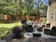 Spacious backyard with a lush lawn, patio furniture, mature trees, and a shed at 3999 Cumberland Se Trl, Conyers, GA 30094