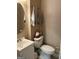Small half bath features neutral colors, a pedestal sink, and a wall mounted towel rack at 3999 Cumberland Se Trl, Conyers, GA 30094