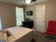 Bedroom with carpet, small desk, and a window letting in natural light at 3999 Cumberland Se Trl, Conyers, GA 30094