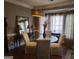 Chic dining room featuring a glass table, upholstered chairs, decorative mirror and a modern light fixture at 3999 Cumberland Se Trl, Conyers, GA 30094