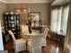 Elegant dining room featuring a glass table, upholstered chairs, decorative mirror and natural light at 3999 Cumberland Se Trl, Conyers, GA 30094