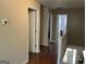 Bright upstairs hallway with hardwood floors, white railings, and open doorways at 3999 Cumberland Se Trl, Conyers, GA 30094