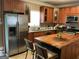Kitchen featuring stainless steel appliances, wood cabinetry, and an island at 3999 Cumberland Se Trl, Conyers, GA 30094