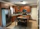 Spacious kitchen featuring a large island with chairs, stainless appliances, and wood cabinets at 3999 Cumberland Se Trl, Conyers, GA 30094
