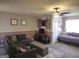 Comfortable living area with gray sectional, storage ottoman, ceiling fan and daybed near a door at 3999 Cumberland Se Trl, Conyers, GA 30094