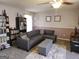 Inviting living space with a gray sectional, storage ottoman, bookshelf, and stylish decor at 3999 Cumberland Se Trl, Conyers, GA 30094