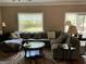 Comfortable living room featuring a large sectional sofa and backyard views at 3999 Cumberland Se Trl, Conyers, GA 30094
