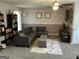 Spacious living room with a comfy couch, bookshelves, and carpeted floor at 3999 Cumberland Se Trl, Conyers, GA 30094
