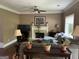 Inviting living room with a fireplace, neutral walls, crown moulding, and a view to the backyard at 3999 Cumberland Se Trl, Conyers, GA 30094