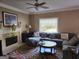 Inviting living room with fireplace, large sofa, and plenty of natural light from the window at 3999 Cumberland Se Trl, Conyers, GA 30094