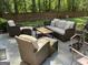 Patio features wicker furniture set including a sofa, chairs, ottomans, and a coffee table, all set in a landscaped yard at 3999 Cumberland Se Trl, Conyers, GA 30094