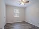 A cozy bedroom features wood floors and a window for natural light at 842 Brighton Dr, Lawrenceville, GA 30043