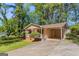 Attractive single-story home with a covered carport and welcoming front porch, surrounded by a well-kept lawn and mature trees at 842 Brighton Dr, Lawrenceville, GA 30043
