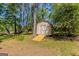 Exterior shot of shed with ramp in wooded backyard at 842 Brighton Dr, Lawrenceville, GA 30043