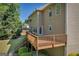 Two-story home featuring a spacious wooden deck with a view of the lush backyard at 1275 Mill Shyre Way, Lawrenceville, GA 30043