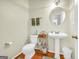 Bathroom with pedestal sink, modern fixtures, and ample space, combining style and functionality at 1275 Mill Shyre Way, Lawrenceville, GA 30043