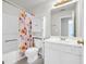 Bathroom featuring a toilet and bathtub with a colorful floral shower curtain at 1275 Mill Shyre Way, Lawrenceville, GA 30043