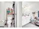 Bright bathroom with double vanity, a toilet and door leading to a shower/bath combo at 1275 Mill Shyre Way, Lawrenceville, GA 30043