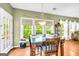 Sunlit dining area with hardwood floors, modern windows, and open flow, creating an inviting dining space at 1275 Mill Shyre Way, Lawrenceville, GA 30043