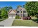 Charming two-story brick home with a well-manicured lawn and a two-car garage at 1275 Mill Shyre Way, Lawrenceville, GA 30043