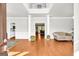 Bright foyer with hardwood floors, white columns, and a view into the living room at 1275 Mill Shyre Way, Lawrenceville, GA 30043