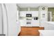 Well-lit kitchen boasts white cabinetry, modern appliances, and hardwood flooring, creating a functional cooking space at 1275 Mill Shyre Way, Lawrenceville, GA 30043