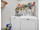 Functional laundry room with a side-by-side washer and dryer and storage shelves at 1275 Mill Shyre Way, Lawrenceville, GA 30043