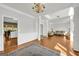Spacious living room with hardwood floors, white trim, and elegant chandelier at 1275 Mill Shyre Way, Lawrenceville, GA 30043