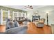 Cozy living room with a fireplace, plush seating, wood floors, and lots of natural light at 1275 Mill Shyre Way, Lawrenceville, GA 30043