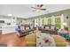 Inviting living room with wood floors and lots of natural light flowing from a kitchen and dining area at 1275 Mill Shyre Way, Lawrenceville, GA 30043