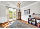 Well-lit office with a large window, hardwood floors, and decorative furnishings at 1275 Mill Shyre Way, Lawrenceville, GA 30043