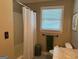 Well-lit bathroom with ceramic tile floor, walk-in shower and large window at 140 Julie Rd, Tyrone, GA 30290