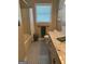 Well-lit bathroom with ceramic tile floor, walk-in shower and large window at 140 Julie Rd, Tyrone, GA 30290